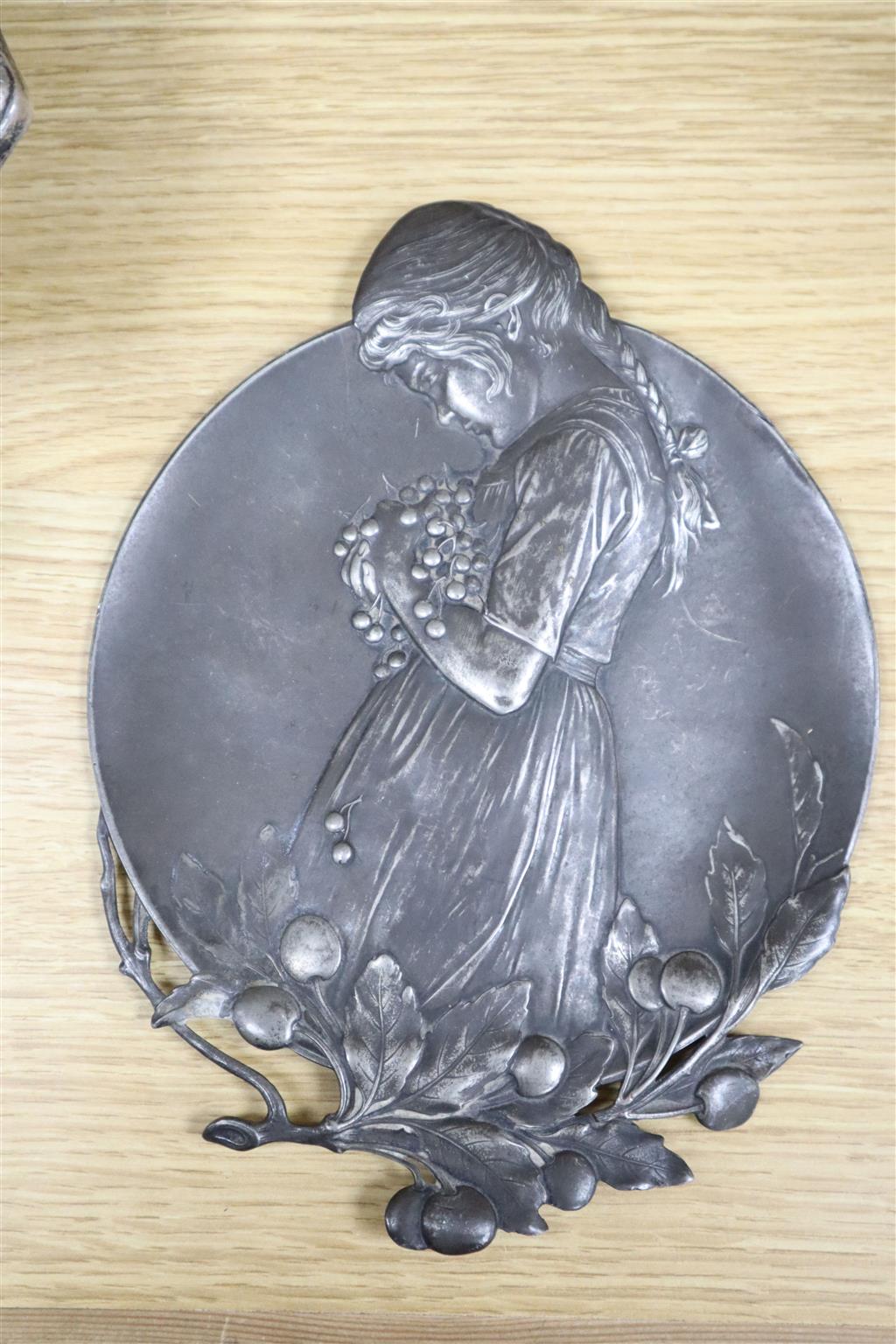 A WMF inkstand, 26cm wide, WMF plaque embossed with a young girl, and three Art Nouveau silver plated serving dishes (5)